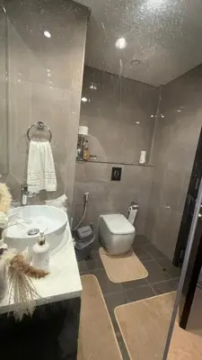 a bathroom with a sink and a toilet at Queens Estate Vacation Homes - Merano Tower, Business Bay in Dubai
