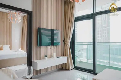 a bedroom with a bed and a tv on a wall at Queens Estate Vacation Homes - Merano Tower, Business Bay in Dubai