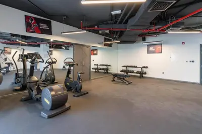 a gym with treadmills and ellipticals in a room at Studio in Samana Golf Avenue - Dubai in Dubai