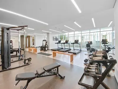 a gym with a row of treadms and machines at Spacious 2 BHK next to the Beach - Sunrise Bay in Dubai