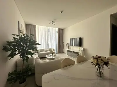 a living room with a couch and a table at Spacious 1bedroom W Lagoon In Al Maktoum City in Dubai
