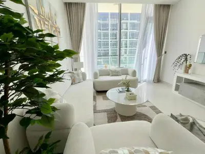 a living room with white furniture and a large window at Spacious 1bedroom W Lagoon In Al Maktoum City in Dubai