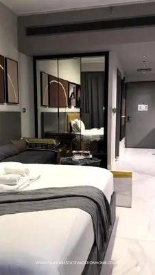 a bedroom with a bed and a living room at Modern Luxurious studio in the Heart of Business Bay in Dubai
