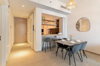a dining room with a table and chairs and a mirror at Wilton Terraces T1 - 1BR Apartment - Allsopp&Allsopp in Dubai