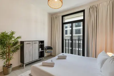 a bedroom with a large bed and a window at Wilton Terraces T1 - 1BR Apartment - Allsopp&Allsopp in Dubai