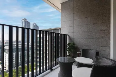 a balcony with chairs and tables on a building at Wilton Terraces T1 - 1BR Apartment - Allsopp&Allsopp in Dubai