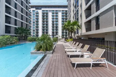 a row of chaise lounge chairs next to a swimming pool at Wilton Terraces T1 - 1BR Apartment - Allsopp&Allsopp in Dubai