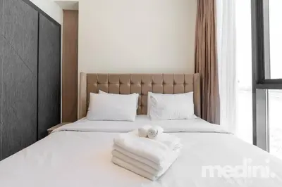 a bedroom with a bed with towels on it at 2 bhk with Private Pool - Samana Golf Avenue - Dubai in Dubai