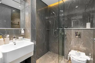 a bathroom with a sink and a glass shower at 2 bhk with Private Pool - Samana Golf Avenue - Dubai in Dubai