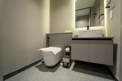 a bathroom with a white toilet and a sink at AWS Holiday Homes - Chic Downtown Views in Dubai