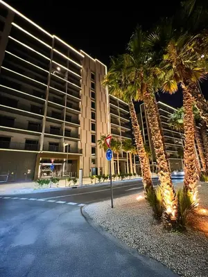 a street with palm trees in front of a building at AWS Holiday Homes - Chic Downtown Views in Dubai