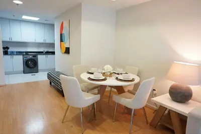 a dining room and kitchen with a table and chairs at Spacious 1-BR close to Barasti Beach and Marina Walk in Dubai