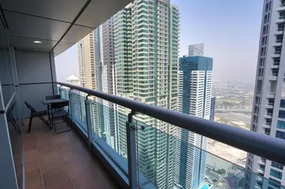 a balcony of a building with a view of a city at Spacious 1-BR close to Barasti Beach and Marina Walk in Dubai