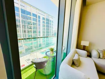 a living room with a couch and a large window at Fully Furnished 1br W Relaxing Lagoon View in Dubai