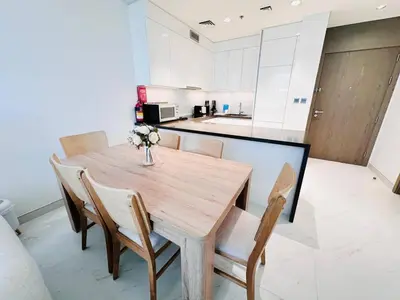 a dining room table and chairs in a kitchen at Fully Furnished 1br W Relaxing Lagoon View in Dubai