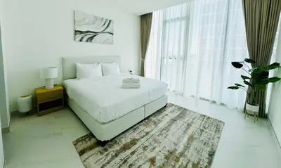 a bedroom with a white bed and a large window at Fully Furnished 1br W Relaxing Lagoon View in Dubai