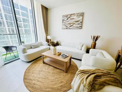 a living room with two couches and a coffee table at Fully Furnished 1br W Relaxing Lagoon View in Dubai