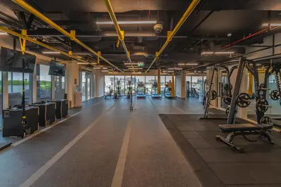 a gym with several treadmills and machines at Oraya - Stylish 2BR in Socio Tower 2 With Pool View in Dubai