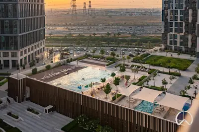 an aerial view of a pool in a city at Oraya - Stylish 2BR in Socio Tower 2 With Pool View in Dubai