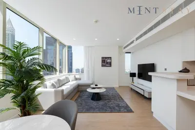 a living room with a couch and a tv at Sky Gardens, Park Avenue, DIFC - Mint Stay in Dubai