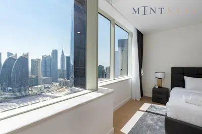a bedroom with a window with a view of the city at Sky Gardens, Park Avenue, DIFC - Mint Stay in Dubai