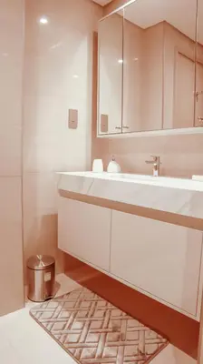 a bathroom with a sink and a mirror and a rug at Burj Royale Condo, Close to Dubai Mall & Attractions in Dubai