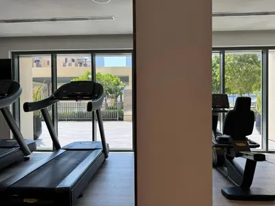 a gym with two treadmills and a treadmill at Burj Royale Condo, Close to Dubai Mall & Attractions in Dubai