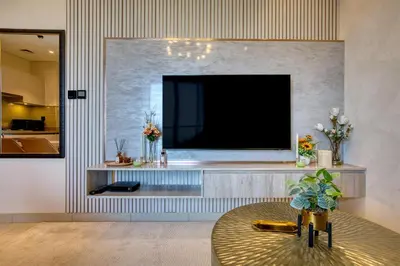 a living room with a flat screen tv on a wall at Apartment 816 Sobha Waves in Dubai