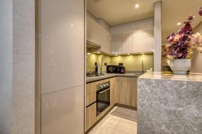 a kitchen with stainless steel appliances and a vase with flowers at Apartment 816 Sobha Waves in Dubai