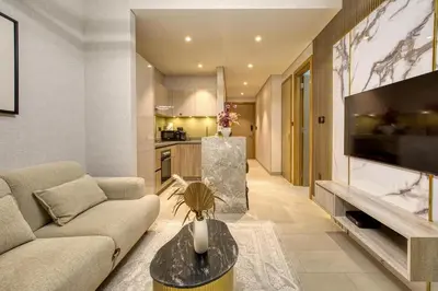 a living room with a couch and a tv at Apartment 816 Sobha Waves in Dubai