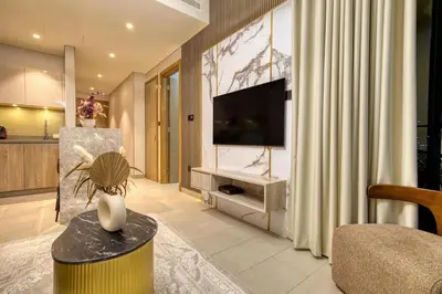 a living room with a doll sitting on a table at Apartment 816 Sobha Waves in Dubai