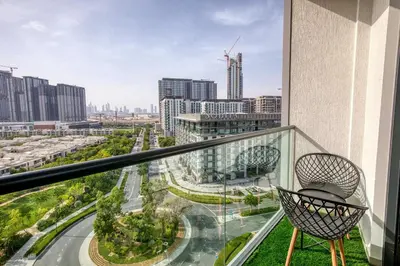 a balcony with a chair and a view of a city at Apartment 816 Sobha Waves in Dubai