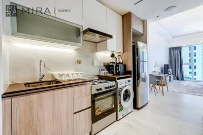 a kitchen with a sink and a stove at Mira Holiday Homes - Fully Furnished Studio in JLT in Dubai