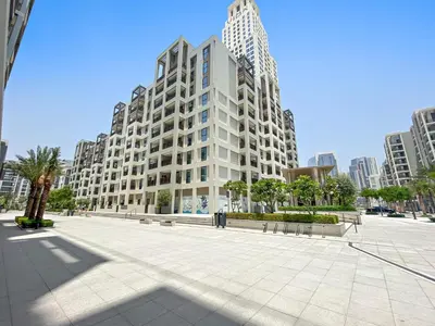 a large white building with benches in front of it at Silkhaus Chic 1BDR In Unique Neighborhood in Dubai