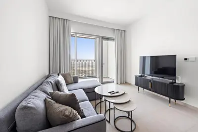 a living room with a couch and a tv at Elegant - 1BR - 8 MIN Burj Khalifa & Dubai Mall in Dubai