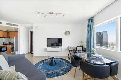 a living room with a couch and a table at 1BR Apartment minutes from Mall of the Emirates in Dubai