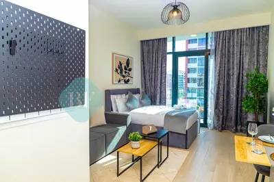 a hotel room with a bed and a couch at Bloomfields Stu View Azizi Riviera Meydan in Dubai