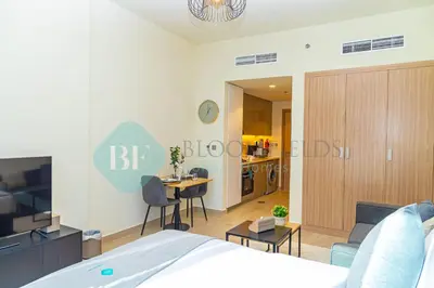 a bedroom with a bed and a living room at Bloomfields Stu View Azizi Riviera Meydan in Dubai
