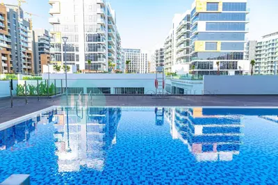 a swimming pool in a city with tall buildings at Bloomfields Stu View Azizi Riviera Meydan in Dubai