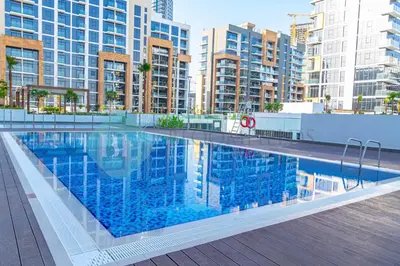 a large swimming pool in a city with tall buildings at Bloomfields Stu View Azizi Riviera Meydan in Dubai