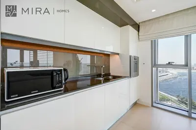a kitchen with a microwave and a counter top at Mira Holiday Homes - Lovely 3 bedroom in Bluewaters with sea view in Dubai