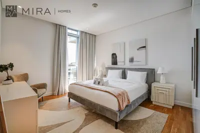 a bedroom with a bed and a living room at Mira Holiday Homes - Lovely 3 bedroom in Bluewaters with sea view in Dubai