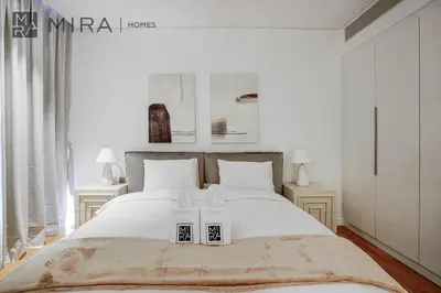 a bedroom with a bed with two boxes on it at Mira Holiday Homes - Lovely 3 bedroom in Bluewaters with sea view in Dubai
