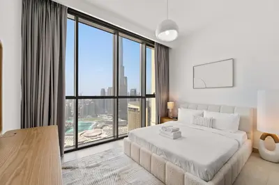 a bedroom with a large bed and a large window at 3BR plus maid's room with Burj Khalifa views in Dubai