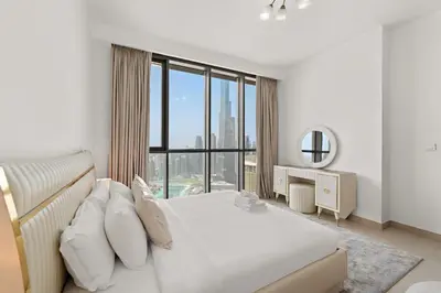 a bedroom with a bed and a large window at 3BR plus maid's room with Burj Khalifa views in Dubai