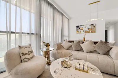 a living room with a couch and a table at 3BR plus maid's room with Burj Khalifa views in Dubai