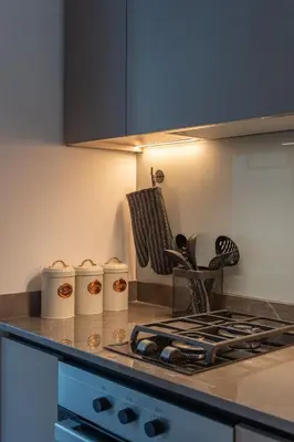 a kitchen with a counter top with a stove at Waves - Comfort and Style in a 21st-Floor Studio With View in Dubai