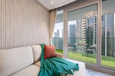 a living room with a couch and a large window at SmartStay at Opera Grand - Stunning Burj Khalifa Views - Brand New Luxury Residences in Dubai