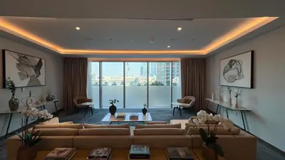 a living room with a couch and a large window at SmartStay at Opera Grand - Stunning Burj Khalifa Views - Brand New Luxury Residences in Dubai