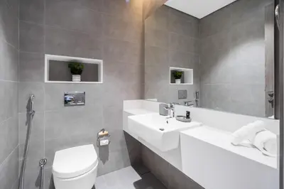 a bathroom with a white toilet and a sink at Your Keys Holiday Homes in Dubai
